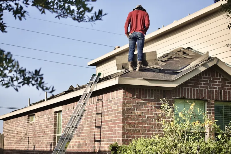 Professional roofer working on a residential roof in Lake Sherwood Corporation